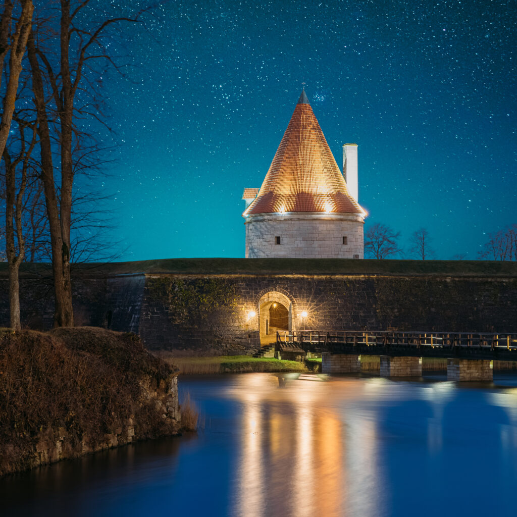 Image depicting castle with a moat at nighttime to capture the notion of a lighting designer building a mote around their design scope on a project.