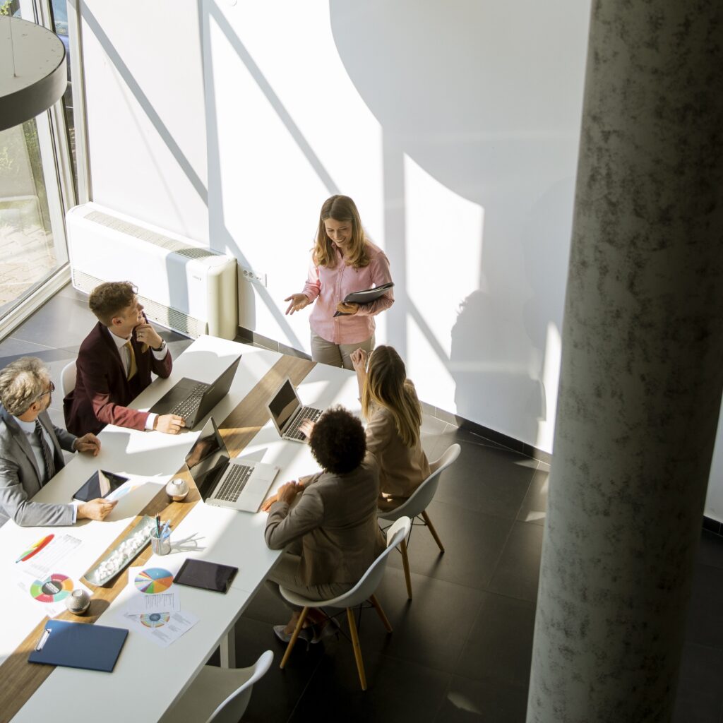 Indicative design-build team that includes Lighting Designer, meeting in a beautiful modern space.