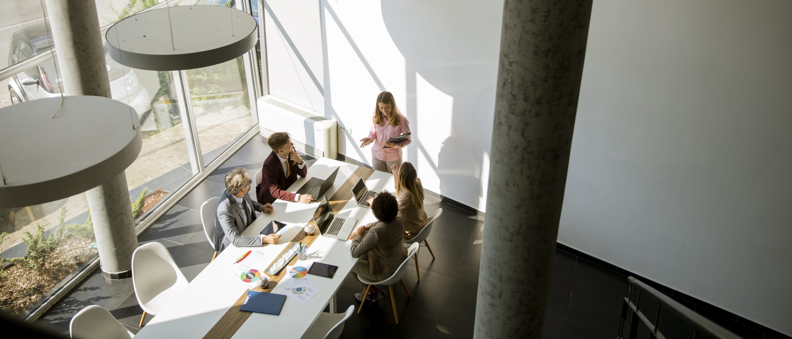 Indicative design-build team that includes Lighting Designer, meeting in a beautiful modern space.